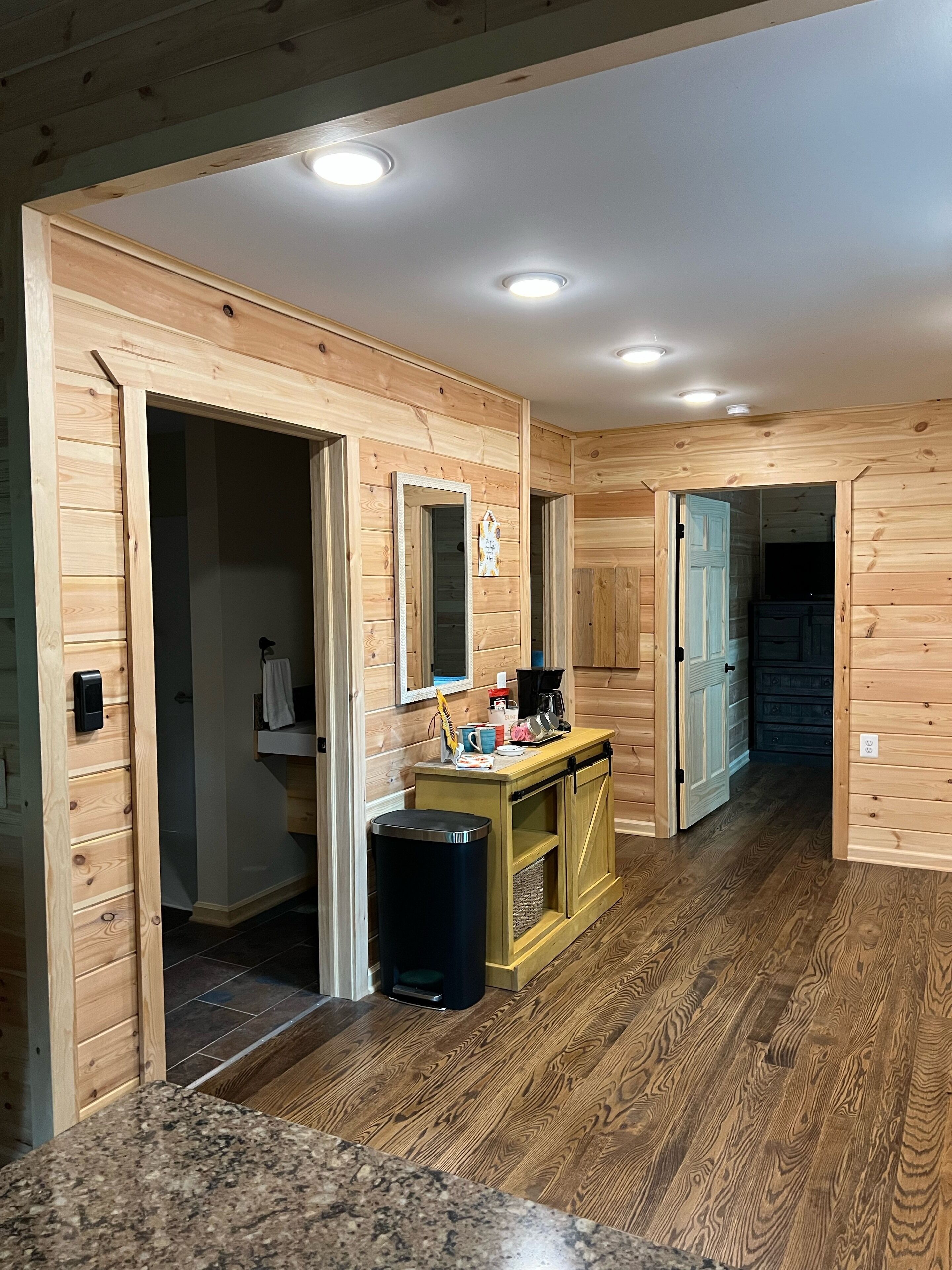 A wooden interior with a kitchen area, a sink, and a countertop.
