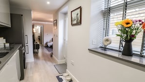 A modern kitchen with a built-in oven and a dining area with a bench. - North Bay Retreat (Scarborough)