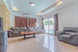 Relax in a spacious living area with a plush sofa set and a functional coffee table.