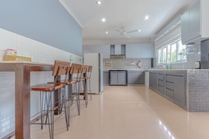 Enjoy cooking in this well-equipped kitchen with a central island, oven, and microwave.