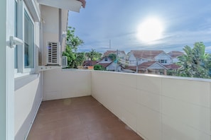 Enjoy a view of the surrounding neighborhood from this balcony.