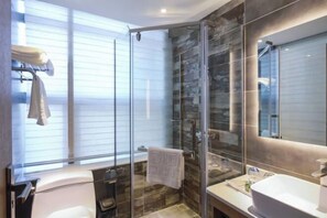 A modern bathroom with a glass-enclosed shower, a large mirror, and a white sink. - Yi She (Chongqing)