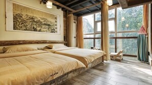 A room with two beds, a large window, and a traditional painting on the wall. - Linmusen Hostel (Chongqing Beibei Pedestrian Street Center) (Chongqing)