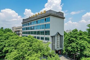 Un edificio de varios pisos con techo plano y un letrero en la parte superior.