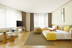 A hotel room with a sofa, a bed with colorful bedding, a television, and a large window with curtains. - Blossom Hill Hotel Ya'an Mengdingshan (Ya'an)