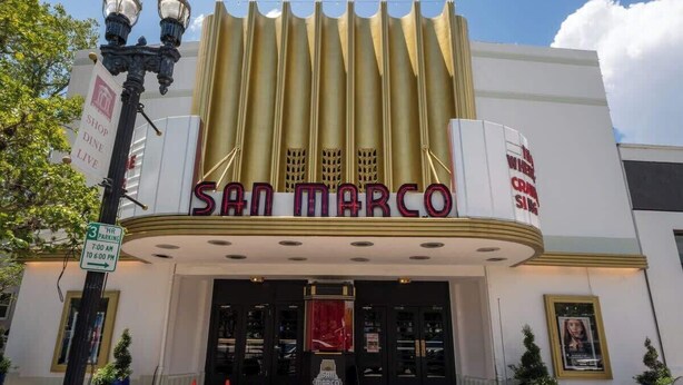 The exterior of the San Marco theater with a marquee, entrance doors, and a sign for hot parking. - Eclectic Escape #2 - Team Joseph Ellen (Jacksonville)