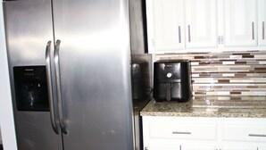 A stainless steel refrigerator with a water dispenser, a coffee maker, and a microwave on the countertop. - Modern and stylish 3 bedroom with large layout floor plan (Lawton)