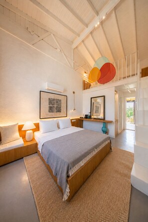 A modern bedroom with a large bed, a nightstand, a wall-mounted lamp, and a ceiling light fixture. -  Voger Alaçatı Social (Cesme)