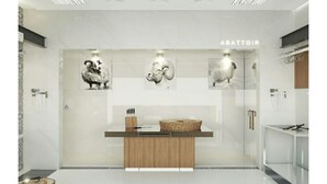 Un baño moderno y minimalista con tocador de madera, cabina de ducha con mampara de vidrio y obras de arte en las paredes.