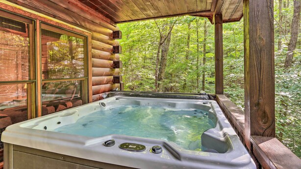 A wooden cabin with a hot tub and large windows overlooking a forest. - 'Bigfoot's Hideout' in Blue Ridge w/ Hot Tub! (Blue Ridge)