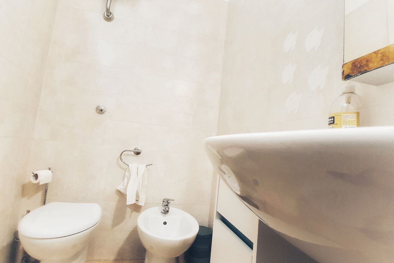 A bathroom with a toilet, bidet, and sink.