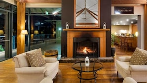 A modern lounge area with sofas and a fireplace. - 2 Bedroom Villa at Cypress Lakes Resort (Pokolbin)