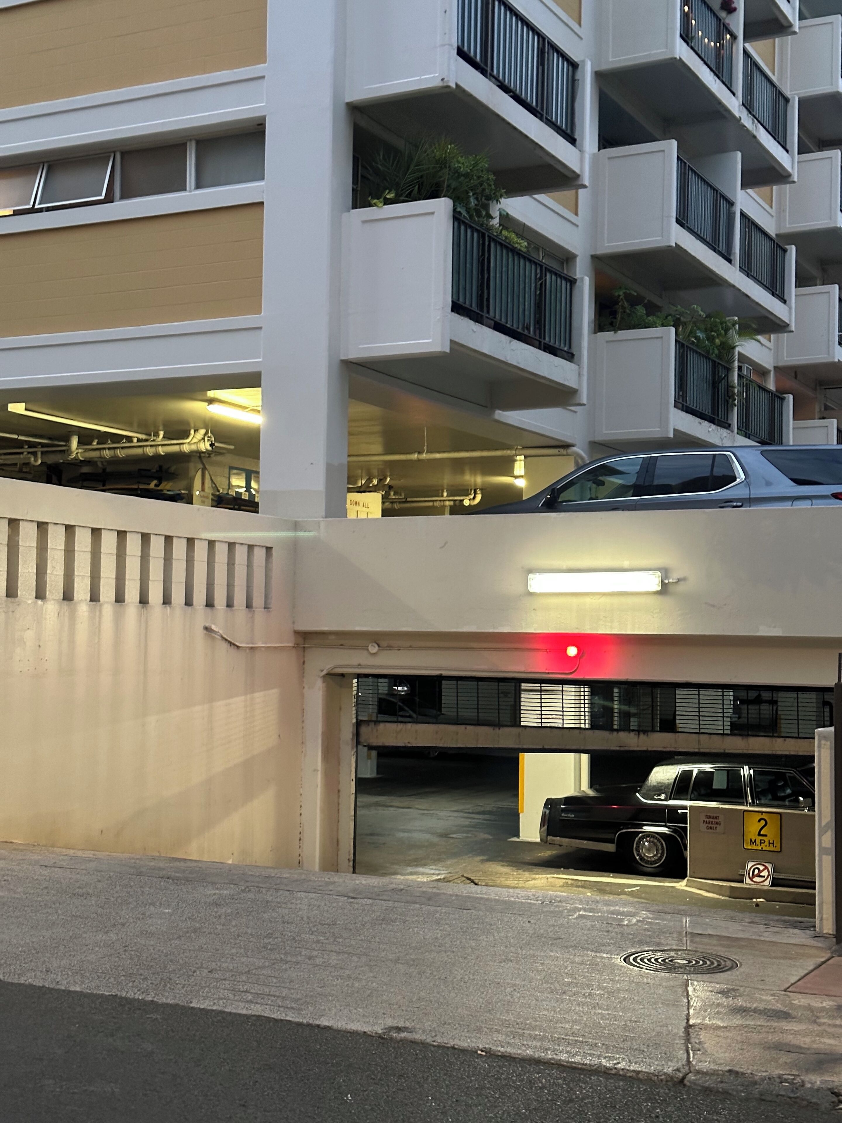 A multi-story parking garage with a car parked inside.