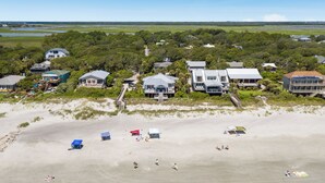 A coastal property with multiple houses, a beach, and a clear view of the ocean. - 1001 E. Arctic - Out Of The Blue - Unique Outdoor Space- Luxury (Folly Beach)