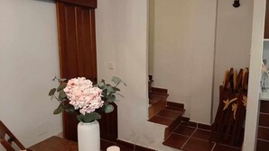 A staircase with wooden steps and a white wall.
