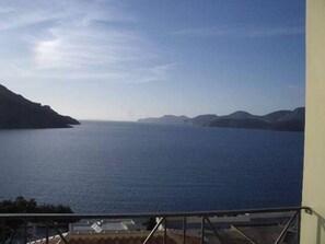 A view of a large body of water with distant landforms, likely a lake or sea, viewed from a balcony with a metal railing. - Apartment - Sleeps 5 - Parking - Private Terrace (Kalymnos)