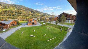 A wooden building with a sign that reads 'Club Hotel' in a rural setting with a grassy area and a mountain in the background. - Superior Apartment # 2 for up to 6 persons with IR Sauna (St. Georgen am Kreischberg)