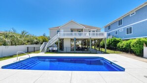 A residential property with a swimming pool, a covered patio, and a two-story house. - Lollipops Beach House - Four Bedroom, Three Bath, Private Pool in Long Bay (Myrtle Beach)