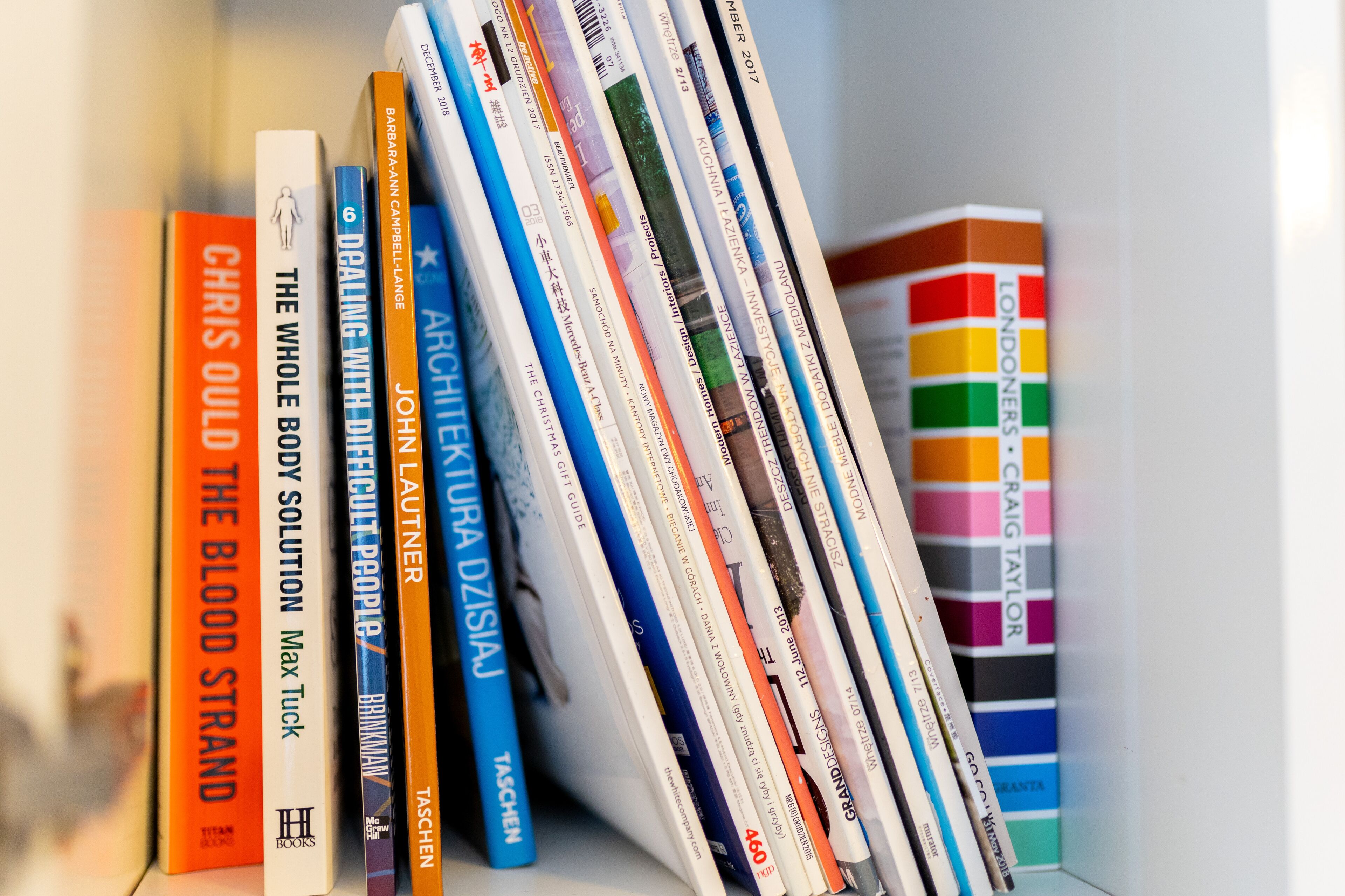 A bookshelf with various books, including titles like "The Whole Body Solution" and "Archipelago."