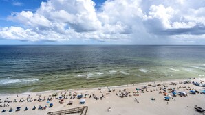 A beach with clear skies and a wooden walkway leading to the water. - Phoenix I 1151 by Liquid Life (Orange Beach)