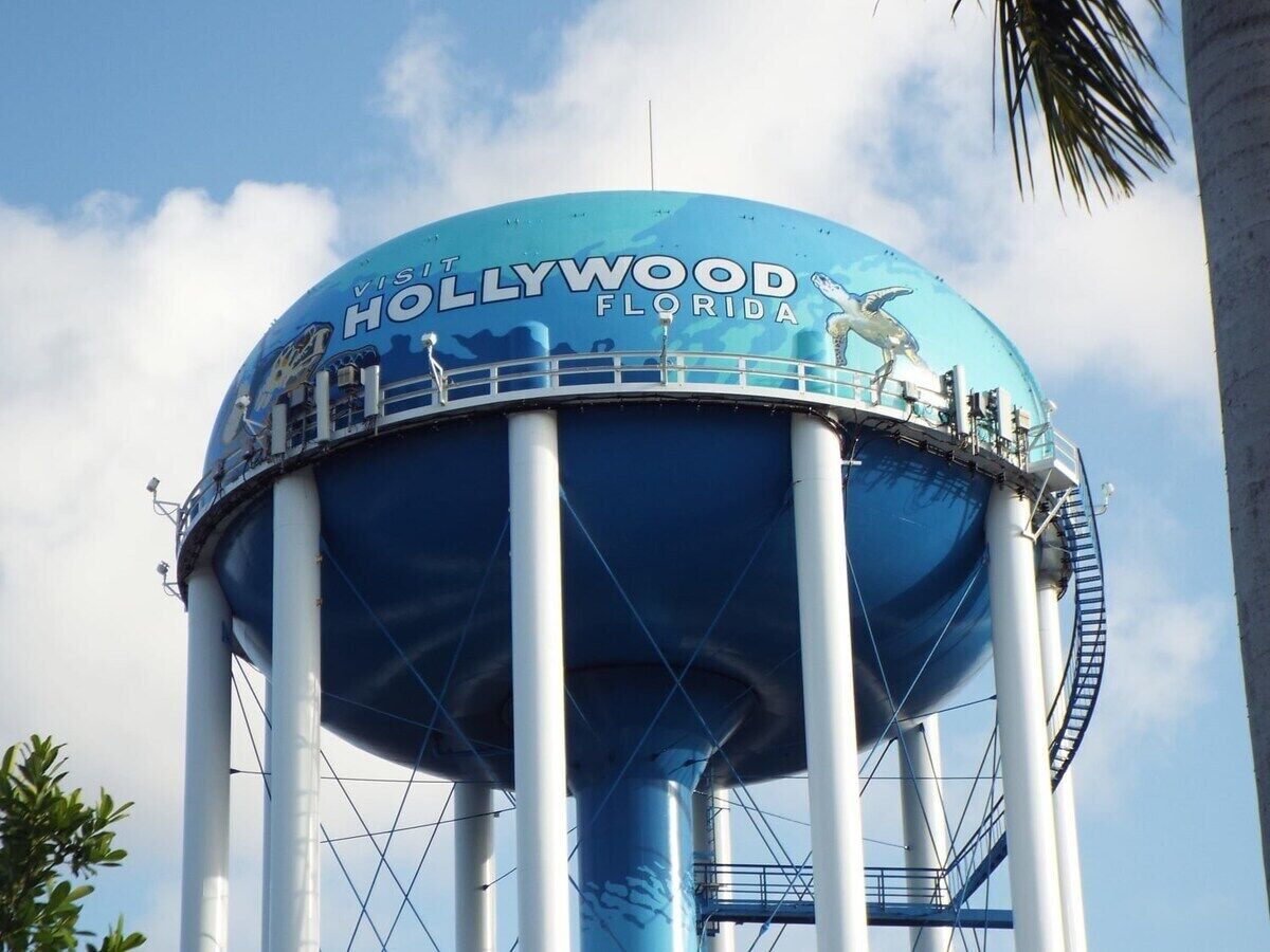A water tower with the Hollywood sign on top.