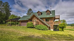 A two-story wooden house with a covered porch, a garage, and a small deck. - 51 Mi to Mt Rainier: Mtn-View Escape on 8 Acres! (Randle)