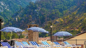 Seasonal outdoor pool, open 9:00 AM to 7:30 PM, pool umbrellas