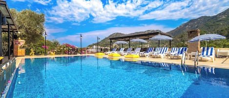 Seasonal outdoor pool, open 9:00 AM to 7:30 PM, pool umbrellas