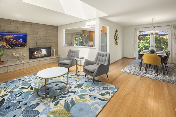 Open space concept featuring a large living room, dining room and kitchen