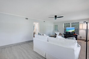 Relax in this stylish living room with a sofa, flat-screen TV, and comfortable chair.