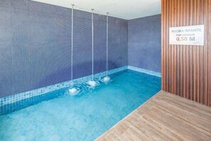 Swimmers can enjoy a refreshing dip in this pool surrounded by a decorative wall.