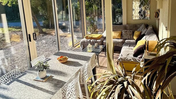 A sunlit patio with a dining table, chairs, and a sofa. - Wonderful place 3* with view and pool (Montesquieu-des-Albères)