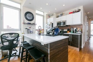 Enjoy cooking in this kitchen with a central island, sink, and ample counter space.