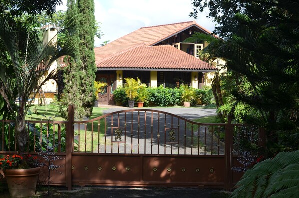 A house with a red-tiled roof, a covered porch, and a gated entrance. - Luxury Private Villa Amazing Views Gated Paradise Starlink Hi-Speed Internet (Cayey)
