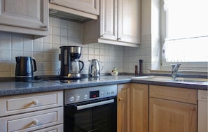 Fridge, stovetop, dishwasher, coffee/tea maker