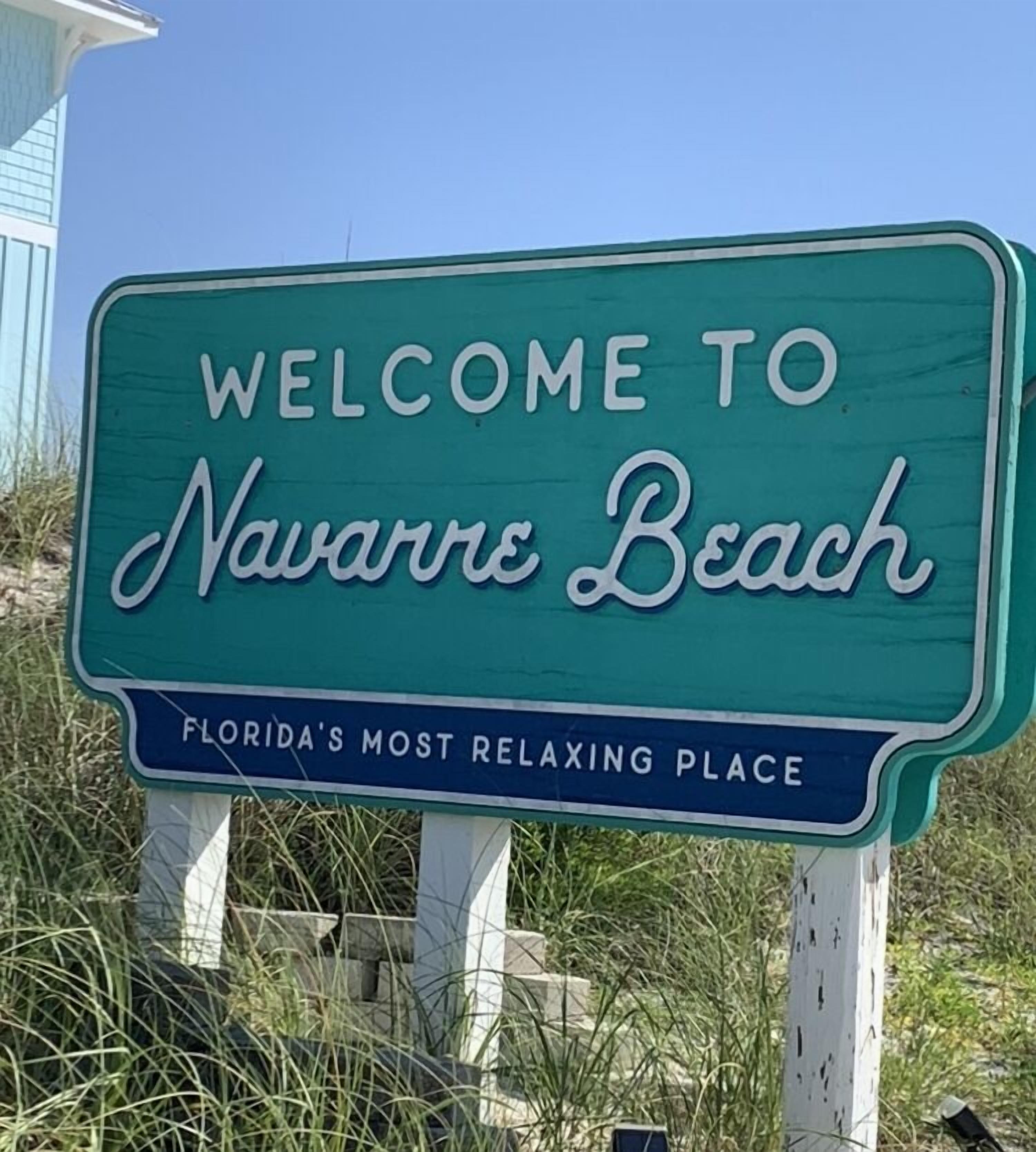 A welcome sign for Navarre Beach, Florida, stating it's Florida's most relaxing place.