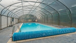 A large indoor swimming pool with a glass ceiling, surrounded by a metal frame structure. - Stunning home in Kværndrup with WiFi (Kværndrup)