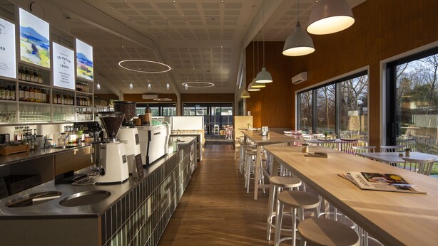 A modern bar area with a long counter, stools, and a coffee machine. - The Vicarage Geraldine (Geraldine)