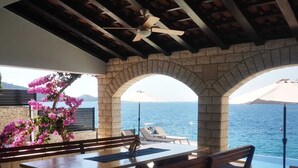 An outdoor seating area with a table and benches, overlooking the sea. - Villa Marijo with sea view and pool, Croatia (Razanj)