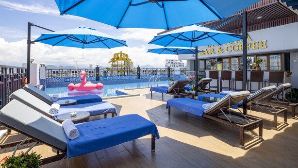 A rooftop pool area with sun loungers, umbrellas, and a bar & coffee shop. - Menora Grand Da Nang (Da Nang)