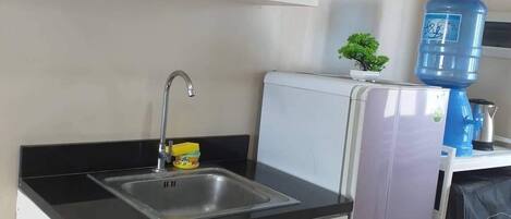 Fridge, electric kettle, cookware/dishes/utensils, dining tables