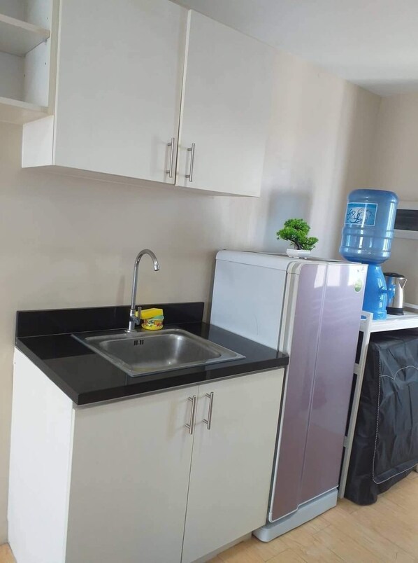 Fridge, electric kettle, cookware/dishes/utensils, dining tables