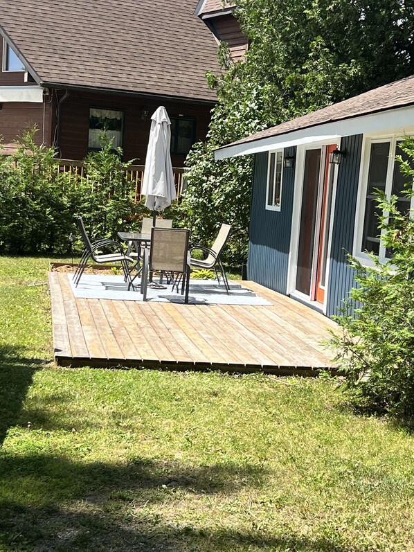 Enjoy dining al fresco on the deck surrounded by a beautifully maintained lawn.