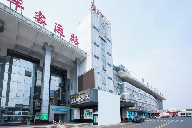 A modern building with large glass windows and a prominent entrance.