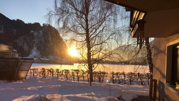 A snow-covered landscape with a vineyard in the foreground and a building with a sloped roof in the background. - Apartment on the outskirts of Strass Zillertal (Strass im Zillertal)