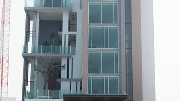 A multi-story hotel with a modern design, featuring a prominent sign for the Mayuu Ayutthaya Hotel.