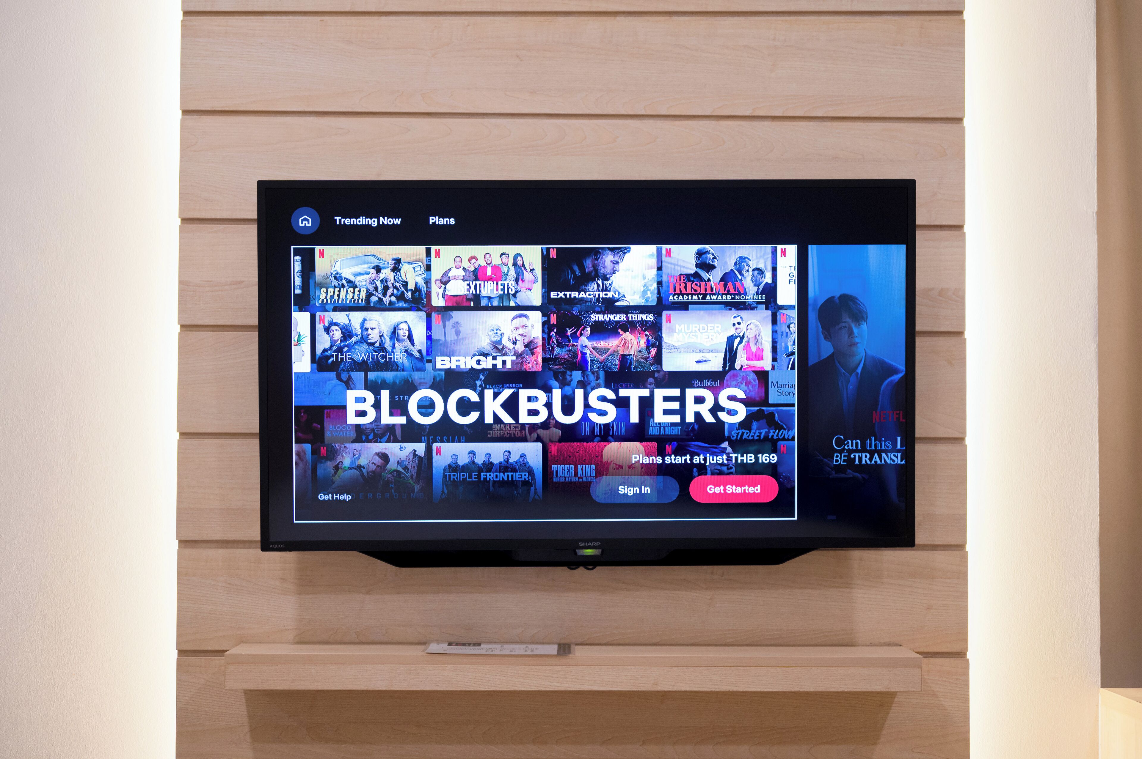 A television displaying a streaming service interface with multiple movie options.