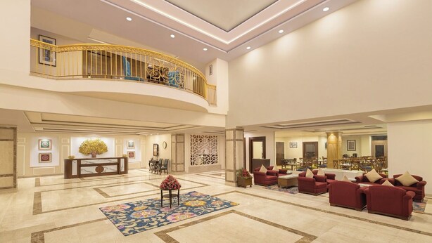 A spacious lobby with a marble floor, a reception desk, a seating area with sofas, and a balcony with a railing. - Fortune Park Kufri, Shimla - Member ITC Hotels' Group (Theog)