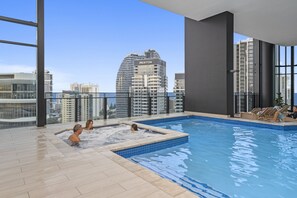 Relax by the pool with a stunning city view.