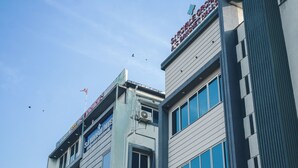 A multi-story building with a sign reading "Hotel & Restaurant" on the top.